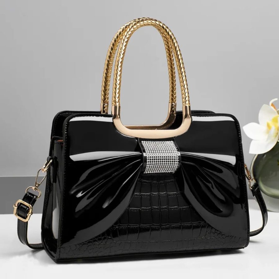 Black patent bow satchel with gold handles