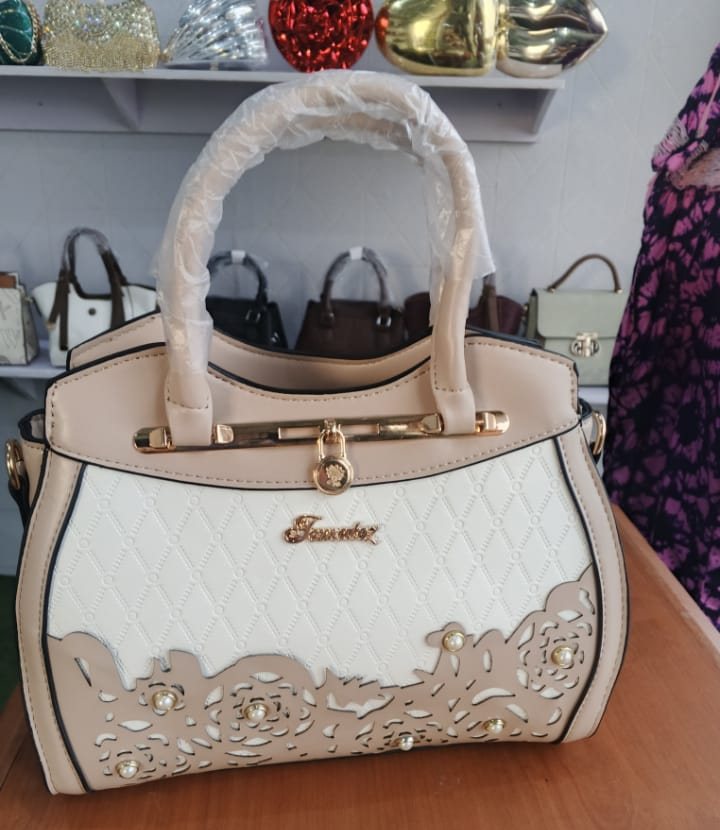 Cream satchel with gold lace-cutout detail