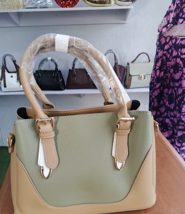Sage green trapeze tote with buckle straps