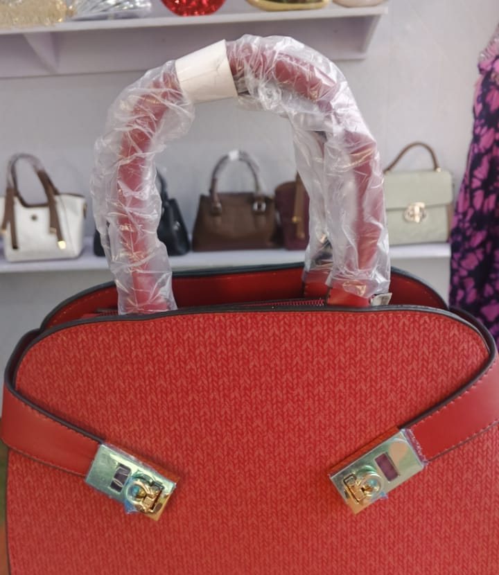 Red frame satchel with twin gold locks